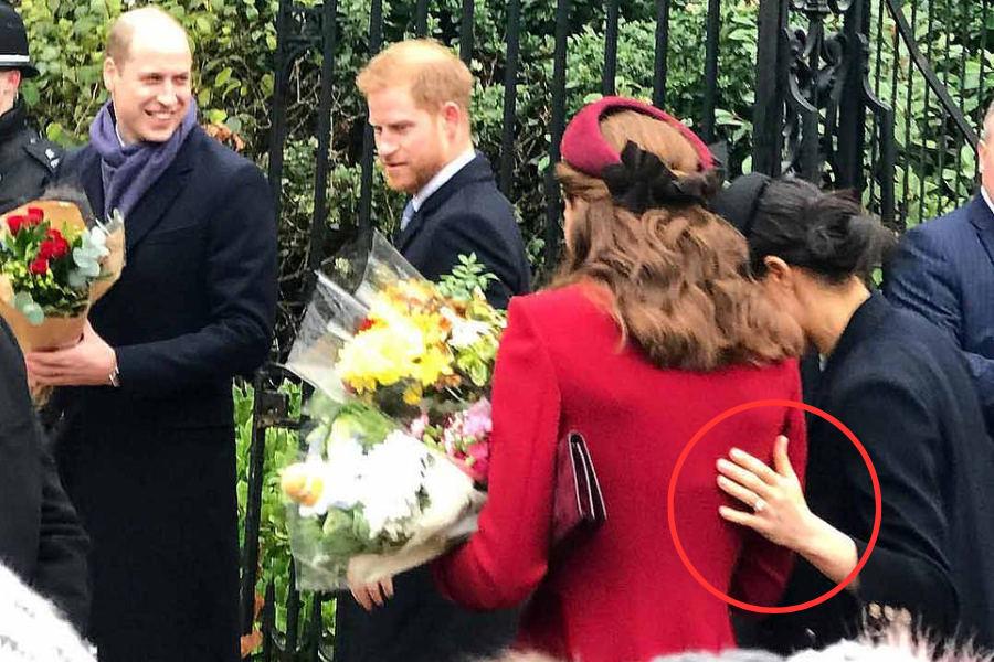 Four royals interact with the public outside a gated area, holding bouquets of flowers. One woman in a red coat is seen from behind as another woman in black appears to reach toward her back, with the moment captured and circled for emphasis. The two men nearby are smiling and engaged with others.