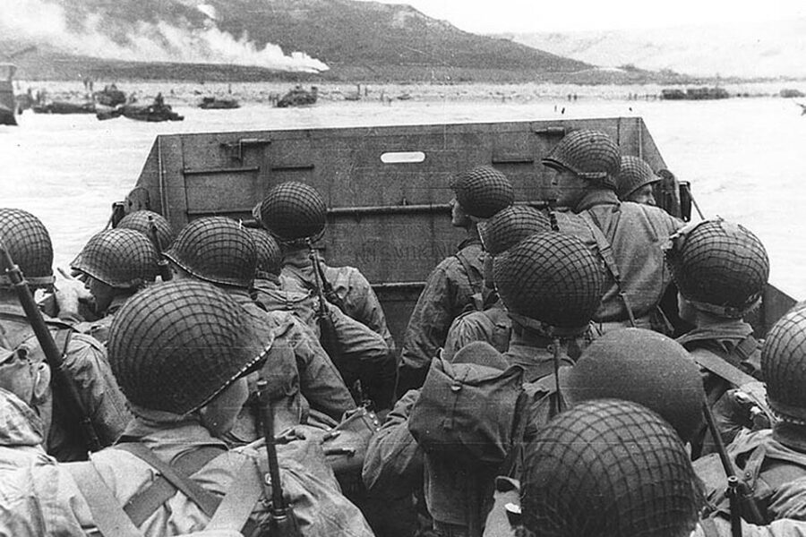 Troops in an LCVP landing craft approach "Omaha" Beach on "D-Day", 6 June 1944.
Note helmet netting, faint "No Smoking" sign on the LCVP's ramp, and the M1903 rifles and M1 carbines carried by some of these men.