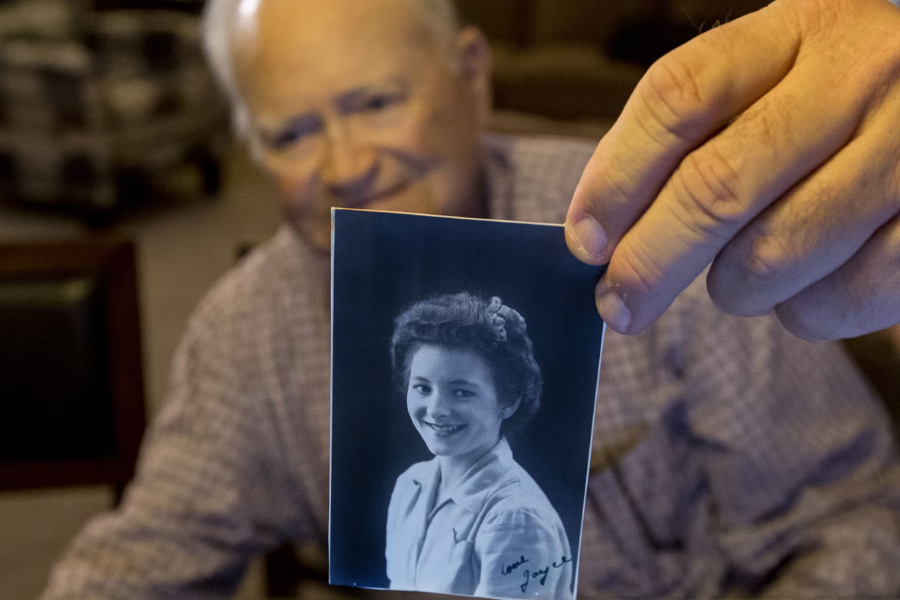 Old man holding vintage photo