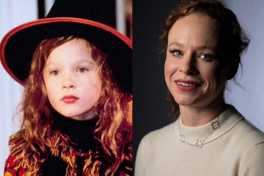 Side-by-side photos of a woman as a child actress and as an adult. On the left, she is a young girl with long curly red hair, wearing a black and orange costume and a wide-brimmed witch hat, looking focused in a film scene. On the right, she is an adult with shorter curly hair styled back, smiling in a cream sweater and floral necklace against a studio backdrop.