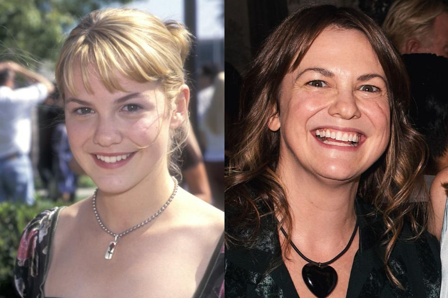 Side-by-side photos of a woman as a young actress and in adulthood. On the left, she is a teenager with blonde hair in a ponytail and side bangs, smiling in a floral dress and silver necklace with a pendant at an outdoor event. On the right, she is older with wavy brunette hair, laughing brightly in a dark top and heart-shaped pendant at an indoor gathering.