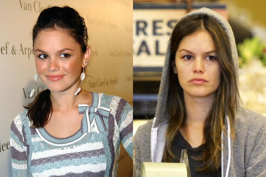 Side-by-side images of a woman in her younger and current years. On the left, she appears youthful with her hair tied back, wearing drop earrings and a striped sweater with a bow, smiling at a branded event backdrop. On the right, she looks older and makeup-free, with long loose hair under a gray hoodie, wearing a neutral expression while holding what appears to be packaging tape in a casual setting.
